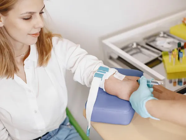A nurse takes a blood sample from a relaxed patient